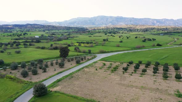 Flying over a road in Cyprus countryside in background of Kyrenia mountains