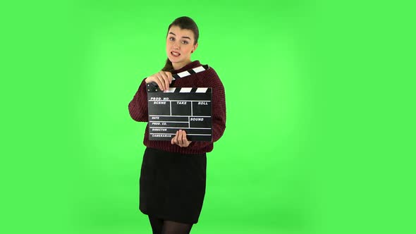Elegant Female Holding Movie Clapper Board, Slate Film. Green Screen