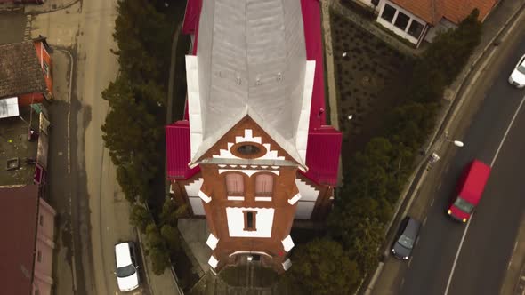 Aerial Drone Close Up and Fly over Of red roofed church in a small Community city village in romania