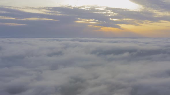 Aerial View Flying Through Cumulus Clouds at Sunset