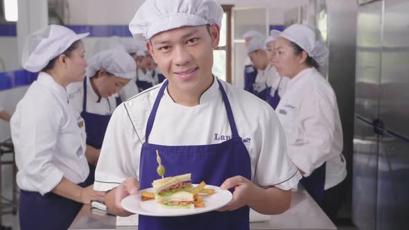 Man Showing His Sandwich At Cooking Classes 