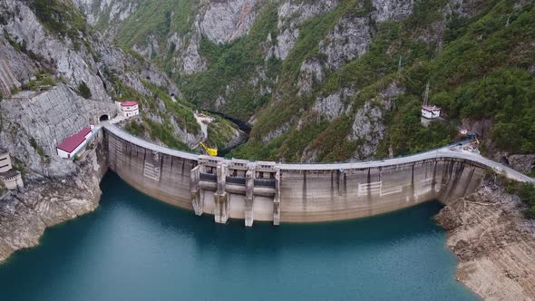 Bird's Eye View of Dam with Sky Blue Water in Mountains