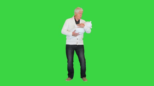 Grandfather Standing and Holding Grandson on a Green Screen Chroma Key