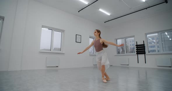 Ballerina in Pointe Shoes Runs Through the Dance Room and Jumps Several Times in Slow Motion Dance