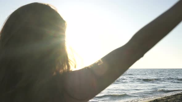 Young Caucasian Woman Practicing Yoga on the Beach Near Calm Sea.