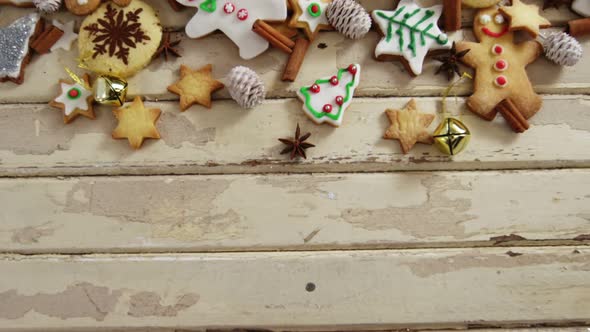 Various christmas cookies and cinnamon on a plank