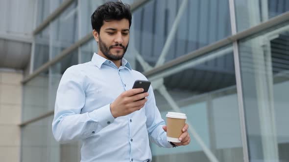 Handsome Business Man With Phone And Coffee On Street