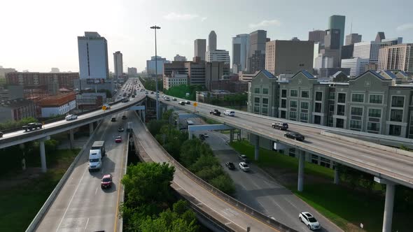 Texas city aerial view. Traffic at rush hour. New apartment building by interstate freeway. Noise co