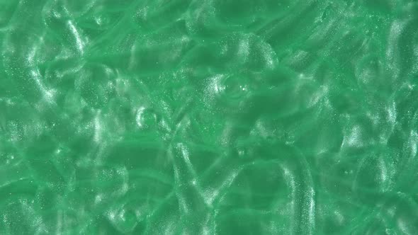 Green Liquid Cream Cosmetic Gel Fluid Motion Rotation on a Surface