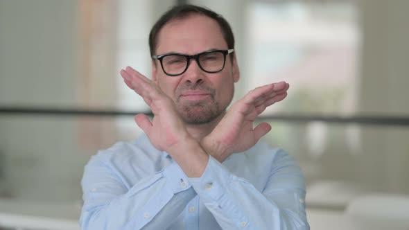 Middle Aged Man Showing No Sign By Arm Gesture