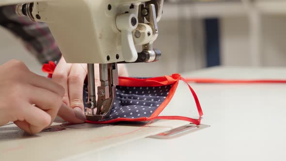 Female Seamstress Using Sewing Machine for Making Mask