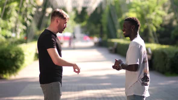 black guy and white guy greet each other in a special greeting