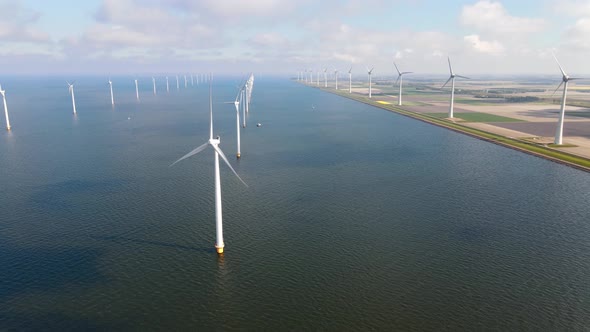 Offshore Windmill Park with Clouds and a Blue Sky Windmill Park in the Ocean Drone Aerial View with