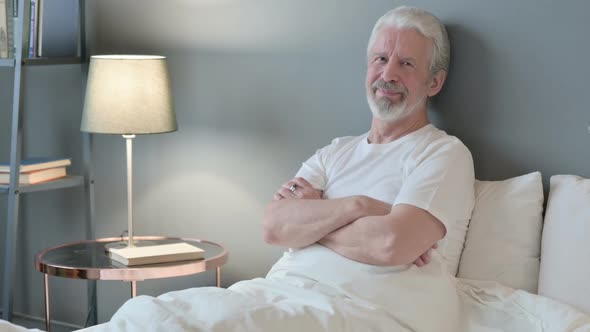 Thumbs Up By Old Man Sitting in Bed Appreciate