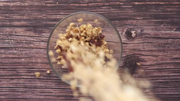 Falling Cereal Breakfast in Bowl on Wooden Background