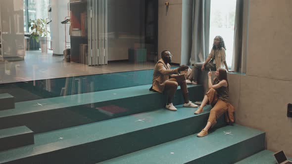 University Students Resting on Stairs Indoors