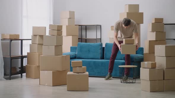 Young Man Moves in Cardboard Boxes
