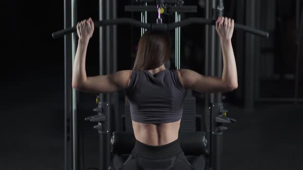 Female in the Gym Lifting Blocks on Rack Machine Strength Training on Block Device and Gym Equipment