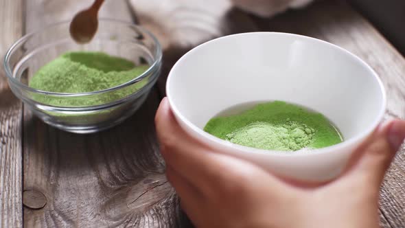 Matcha Process Of Making Green Tea In White Bowl On Wooden Table Background. Matcha Green Tea