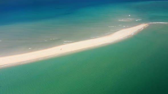 Aerial Footage of a Man Running Towards the Open Waters