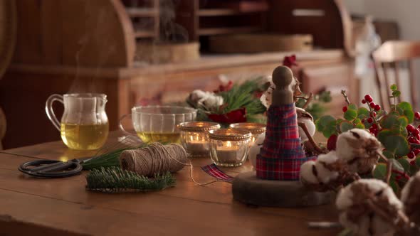 Festive Christmas composition with glass cup of tea against wooden background