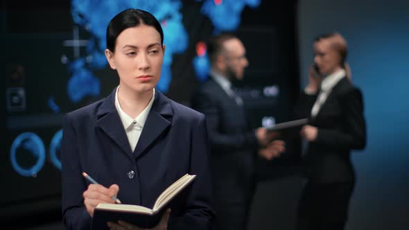 Successful Asian Female Manager Making Notes with Pen at Paper Diary