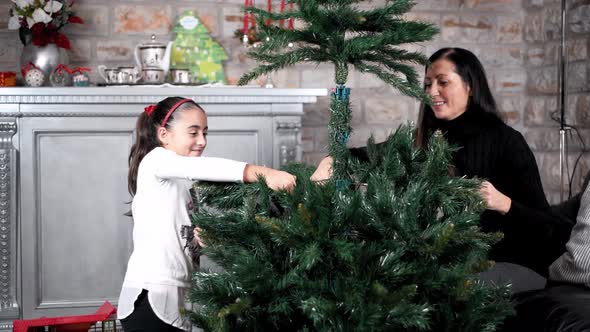 Family Decorating Christmas Tree at Home Holiday Concept