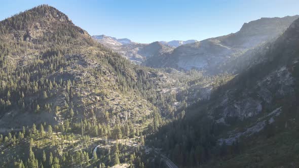 Drone flying over emerald bay towards Eagle Falls and Desolation Wilderness  During golden hour Taho