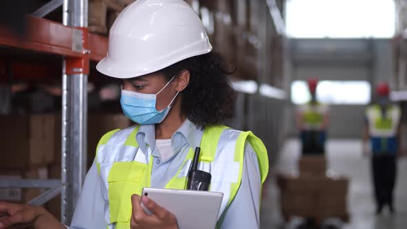 Inventory Manager Working on Tablet in Storehouse