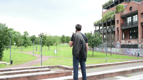 Young beautiful man from the back looking away feeling free