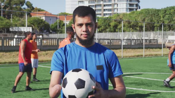 Soccer player looking at camera on the field