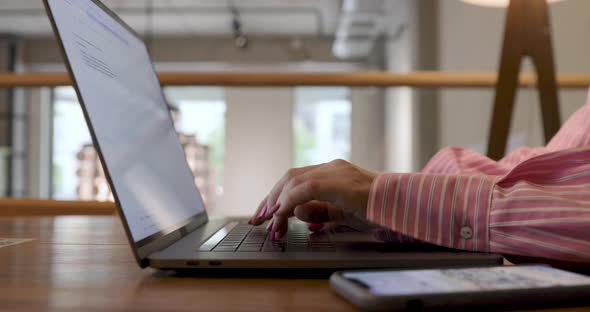 Hands of businesswoman professional user worker typing on the laptop notebook keyboard.