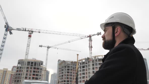 Businessman Looks at the Construction Site