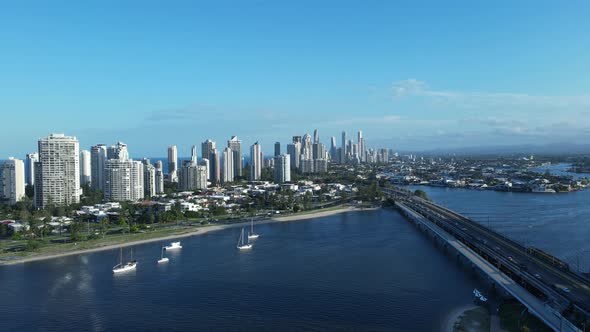 A revealing high drone capture of a urban city sprawl with large bodies of water surrounding the hig