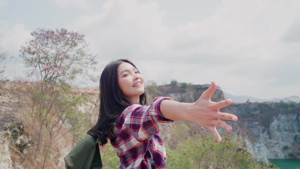 Asian backpacker woman walking to top of mountain, Female enjoy her holidays.