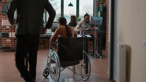 Woman with Physical Disability Looking at Charts and Graphs