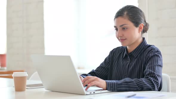 Young Indian Woman Working on Laptop 