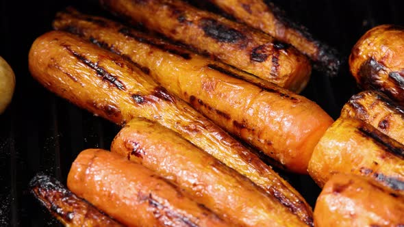 Cooking new carrots in charcoal grill