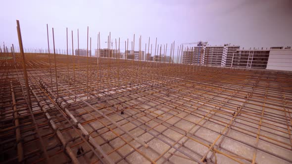 Iron reinforcement is basis for pouring foundation of house with concrete slab.