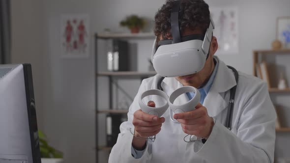 Professional Young Man Doctor Working in Hospital Office Using Virtual Reality Technology