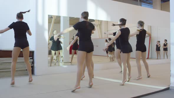 Teen Cheerleading Team Practicing Routine