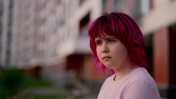 Difficult Teenager Girl is Looking at Camera Outdoors in City Portrait of Girl with Vivid Pink Hair