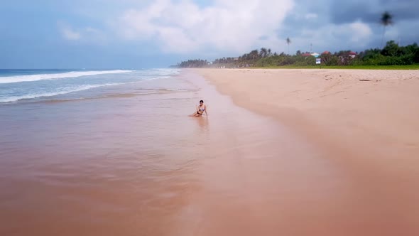 Happy Asian Woman Sitting on Sandy Beach Summer