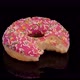 Donut with pink icing and colorful sprinkle rotating on a black background.  - VideoHive Item for Sale