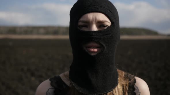 Girl in Ski Mask Is Standing Cross-handed