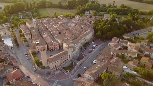 Panning shot of an old medieval city during a sunset, Italy