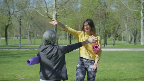 Woman Waving Hand, Greeting Another Woman, They Kissing, Hugging