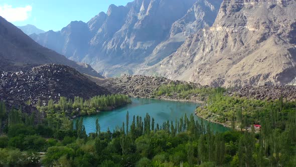 Aerial view of turquoise blue water at upper kachura lake surrounded by forest in skardu pakistan on