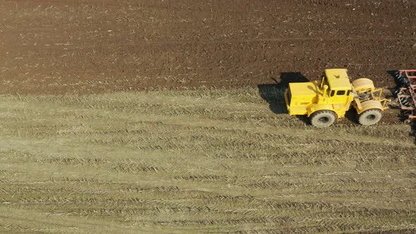 Tractor with Disc Harrows on the Farmland