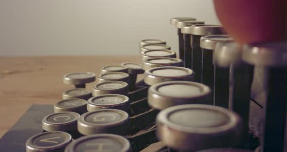 Special macro dolly shot hovering over old typewriter keys with male hand typing